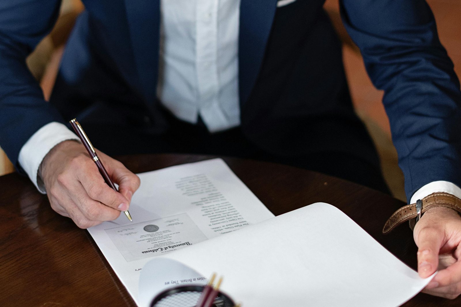 Lawyer at desk reviewing documents with pen, representing law firm SEO strategy and digital marketing